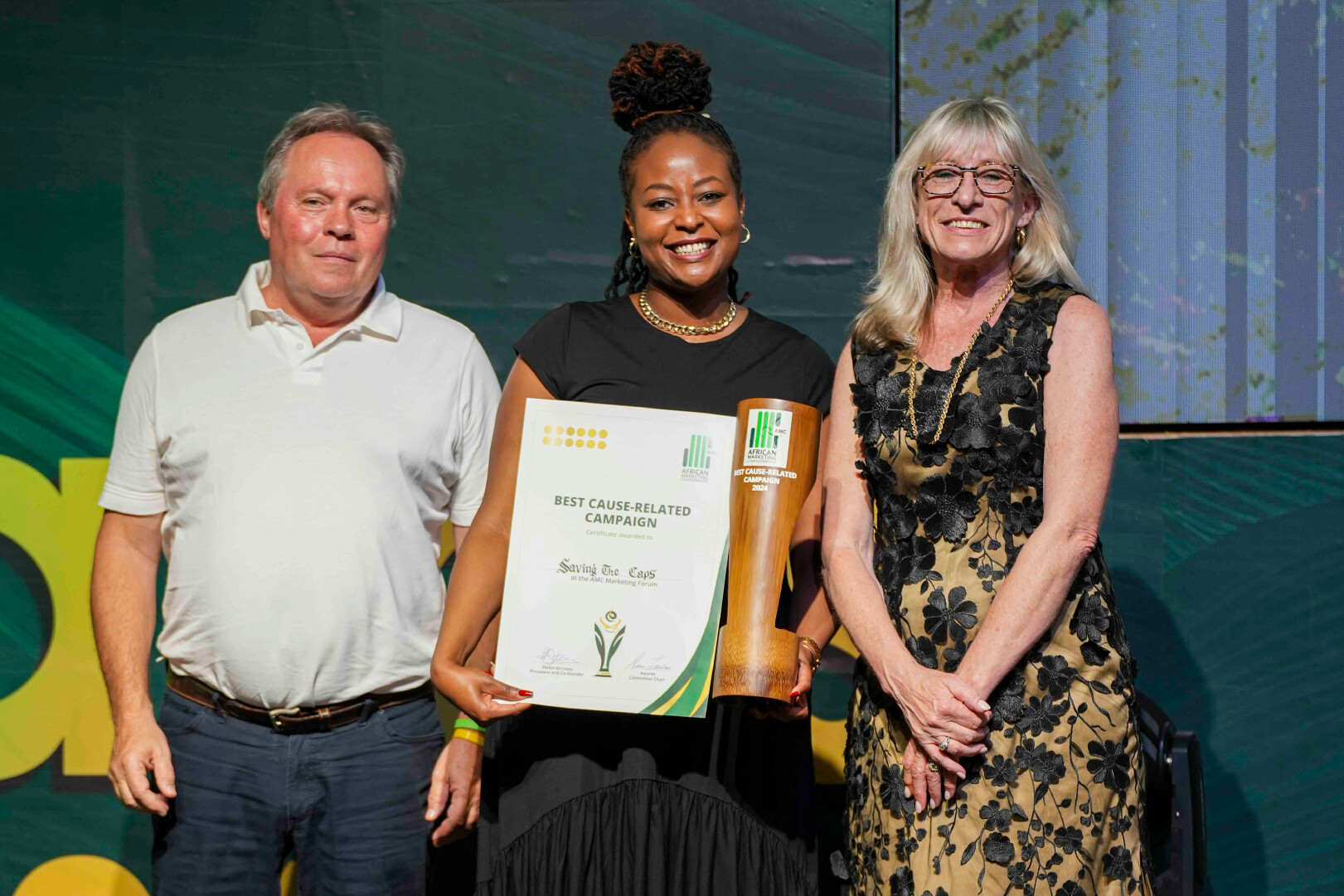 photo of the winners of the best cause related campaign. White Cap Kenya won gold for its Saving the White Caps project L-R Nigel Tattersall, Gloria Kaburu and Helen McIntee