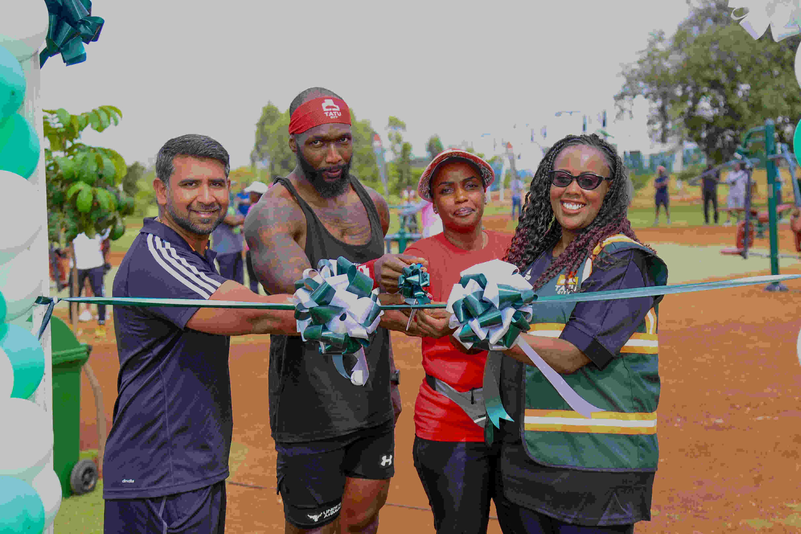 L-R, Amit Joshi, Senior Project Manager, Tatu City, Kelvin Owako, Fitness Trainer, Kanana Ndegwa, Head of Marketing, Unity Homes, and Angela Muthoga, Events and Sustainability Manager Tatu City, cut a ribbon to launch the outdoor gym at Tatu City.