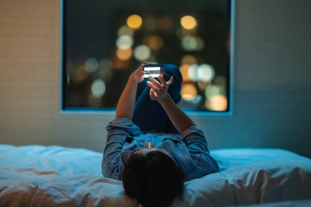 woman with phone in bed