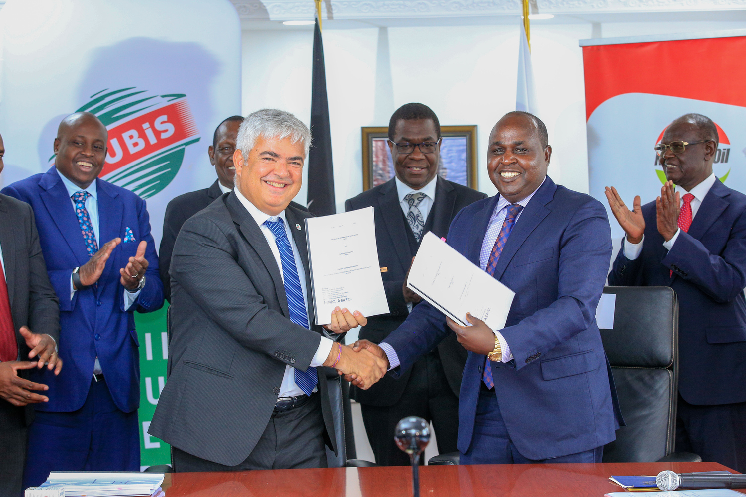 From Left (in front): Olivier Sabrié - RUBiS Energie East Africa Group CEO and Managing Director of RUBiS Energy Kenya and Leparan Ole Morintat - CEO & Managing Director of NOC shake hands after signing a non-equity strategic partnership agreement at Kawi Complex earlier today. Looking on is (2nd row) Mr. Daniel Kiptoo Bargoria- Director General of the Energy and Petroleum Regulatory Authority (EPRA), Mr. Mohamed Liban, Principal Secretary for the State Department for Petroleum, Hon. Opiyo Wandayi, Cabinet Secretary for Energy and Petroleum, and Kiraitu Murungi E.G.H, Chairman of the National Oil Corporation.