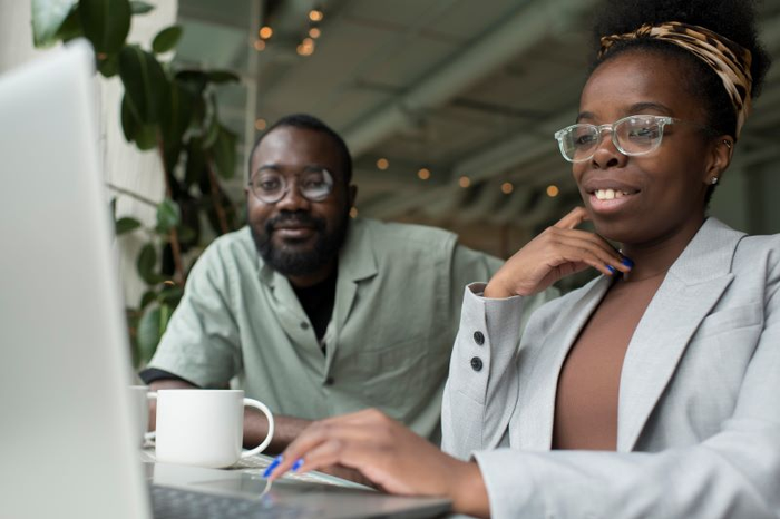 man and woman check laptop