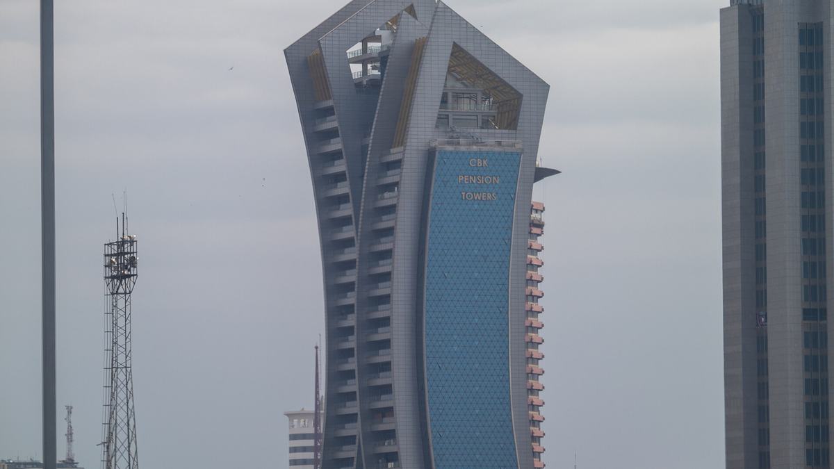 The curved Central Bank of Kenya Pension Towers building in Nairobi seen from below