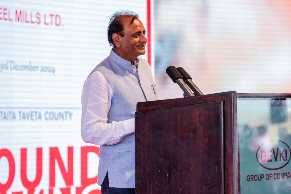 Devki Group of Companies executive chairman speaks at a Devki-branded podium during an earlier company groundbreaking event