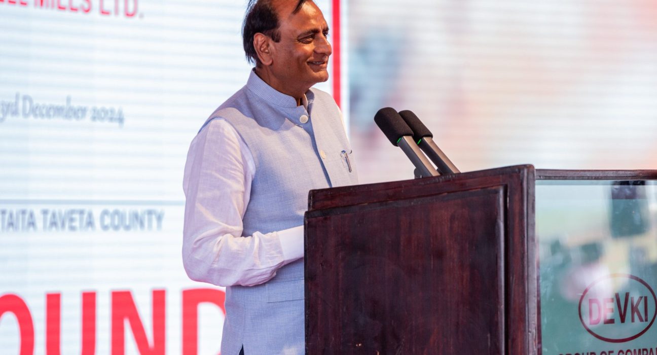 Devki Group of Companies executive chairman speaks at a Devki-branded podium during an earlier company groundbreaking event