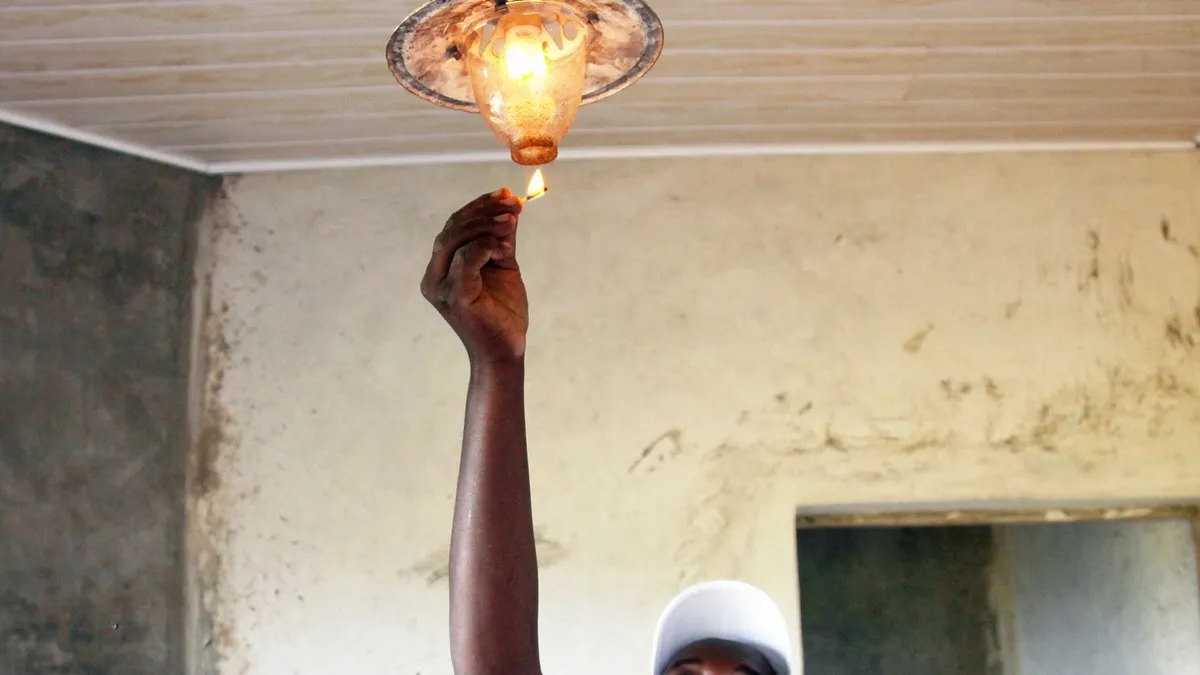 Kenyan man switching on a lamp at home: epra electrician licence