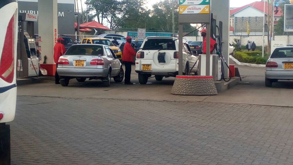 Cars queue at fuel pumps at a petrol station in Kenya