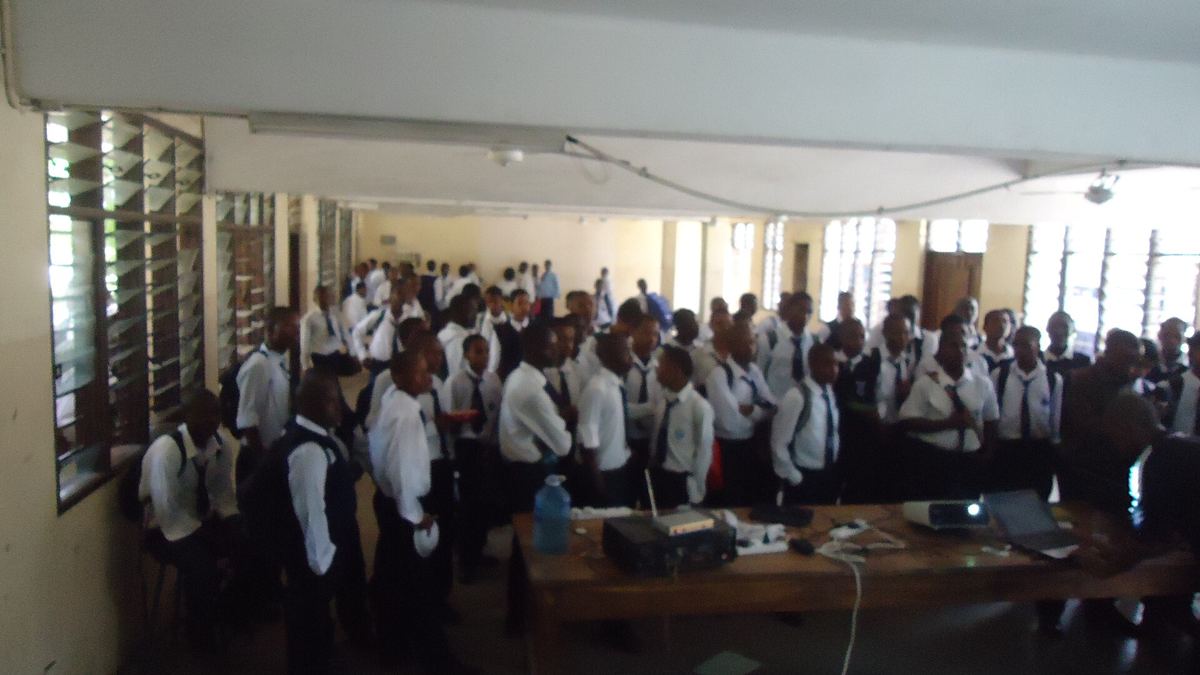 Students follow a presentation at a Kenyan secondary school