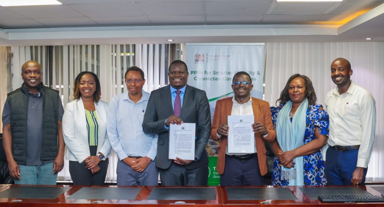 PPP Directorate Director General Kefa Seda and KoTDA CEO John Paul Okwiri hold the signed Konza data centre funding agreement with officials in Nairobi