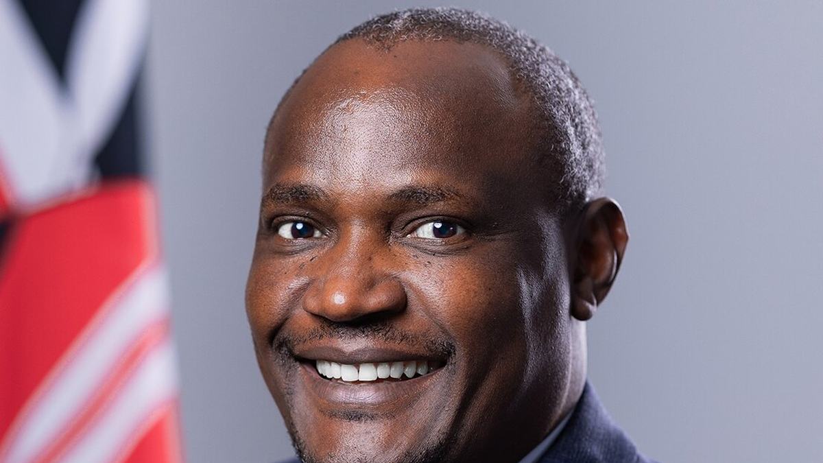 Official portrait of Treasury Cabinet Secretary John Mbadi in front of the Kenyan flag
