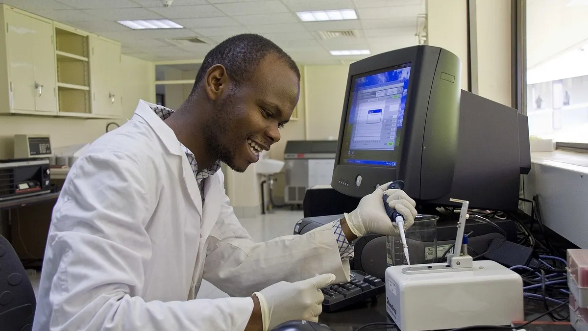 Kenyan scientist working at a laboratory computer – illustrating Nurse Salary in Kenya: Job Groups, Basic Pay and Take-Home Calculator