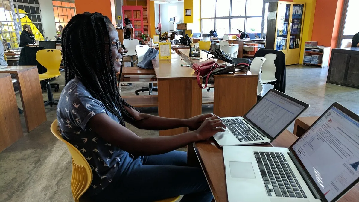 Kenyan analyst working on laptops in an open-plan office: illustrating PAYE tax bands 2026