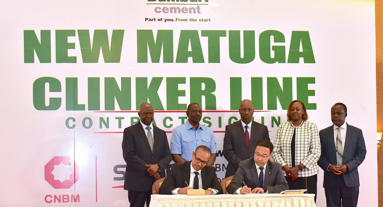 Bamburi Cement and Sinoma CBMI officials sign the New Matuga Clinker Line contract in front of a Bamburi Cement banner