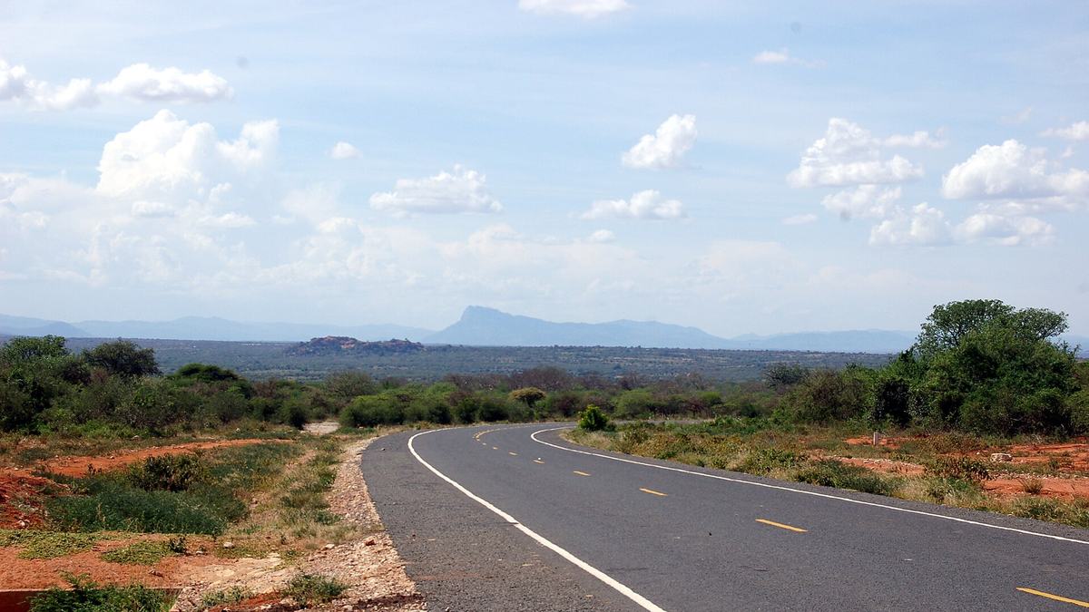 A newly tarmacked road running through dry scrubland in Machakos County