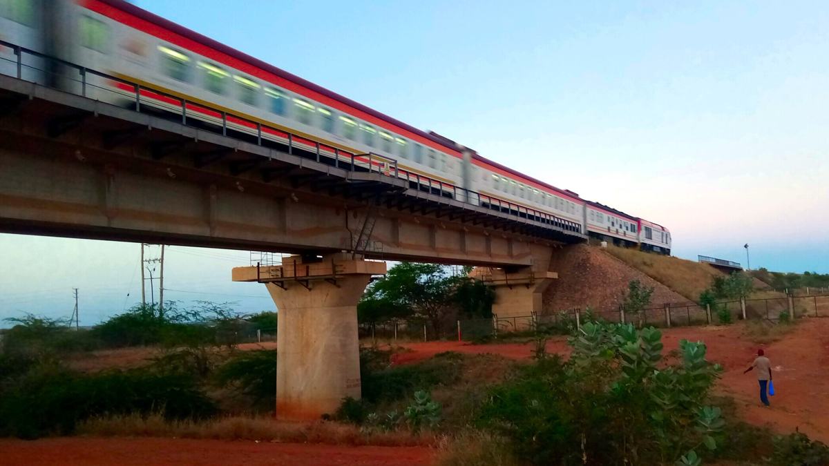 Madaraka Express passenger train crossing a standard gauge railway bridge in Kenya