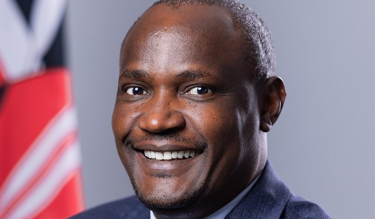 Official portrait of Treasury Cabinet Secretary John Mbadi in front of the Kenyan flag
