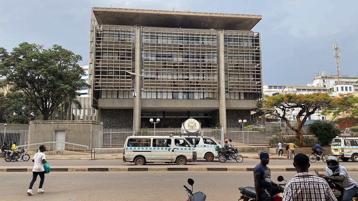 Bank of Uganda building in Kampala with boda boda riders and pedestrians on the road in front