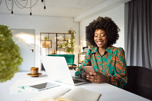 woman with phone and laptop